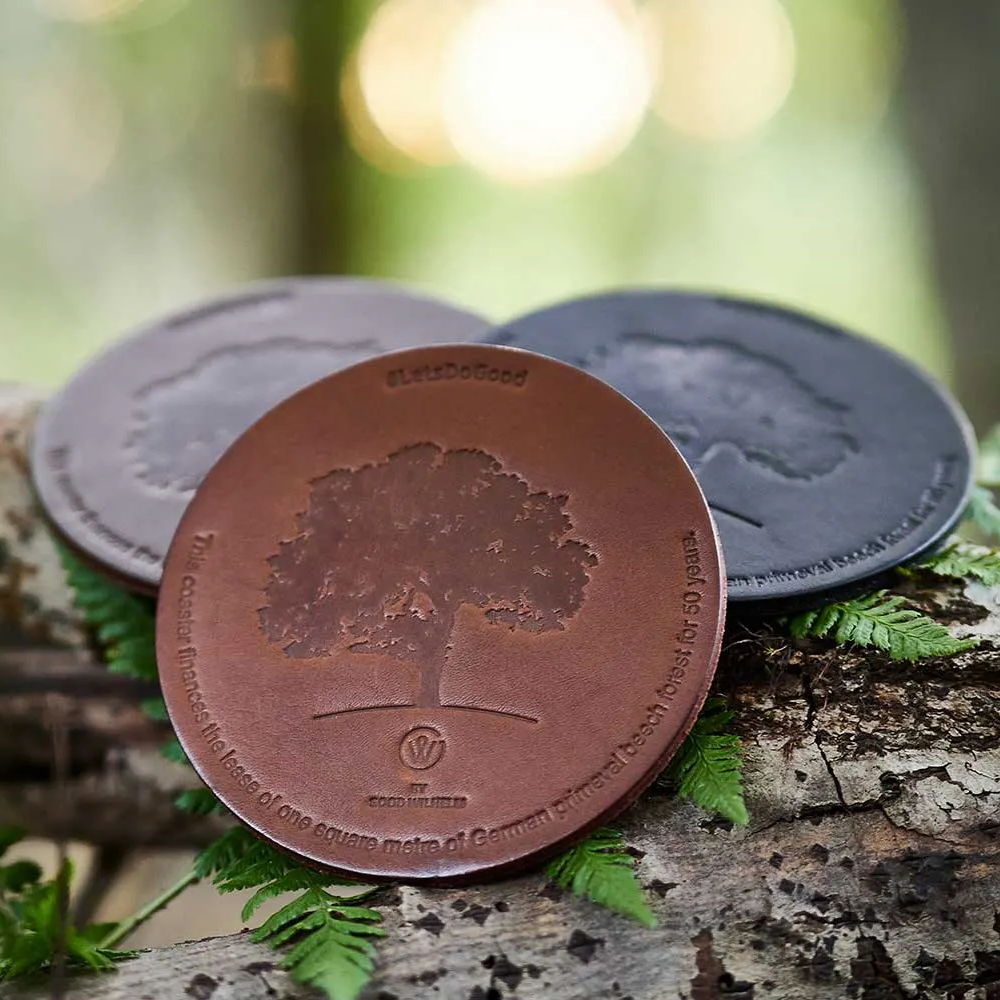 Three leather coasters from Goodwilhelm on tree trunk
