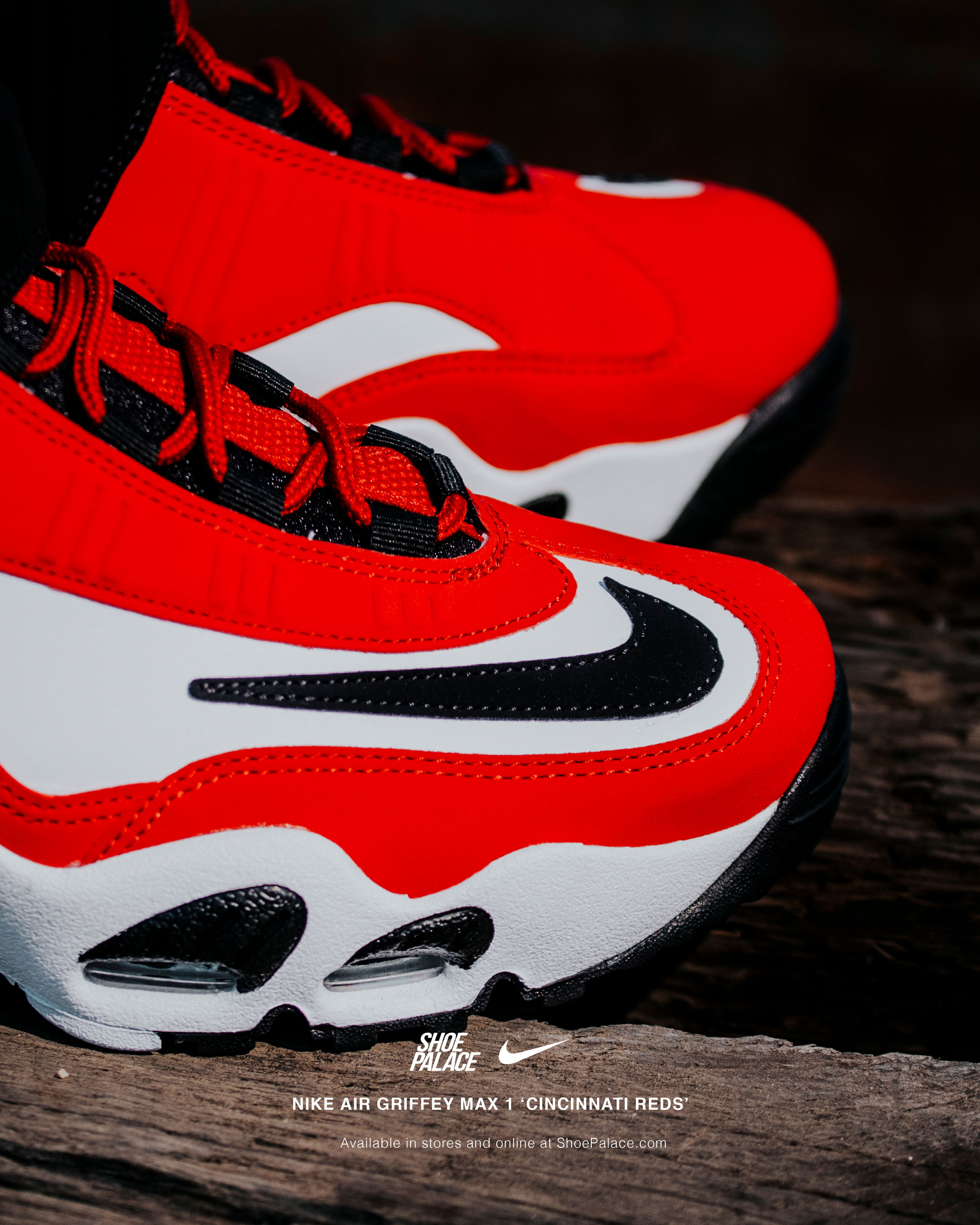 Red and white Nike sneakers on a wooden surface.