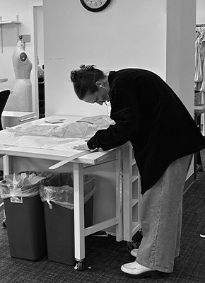Person working at a table in a design studio.