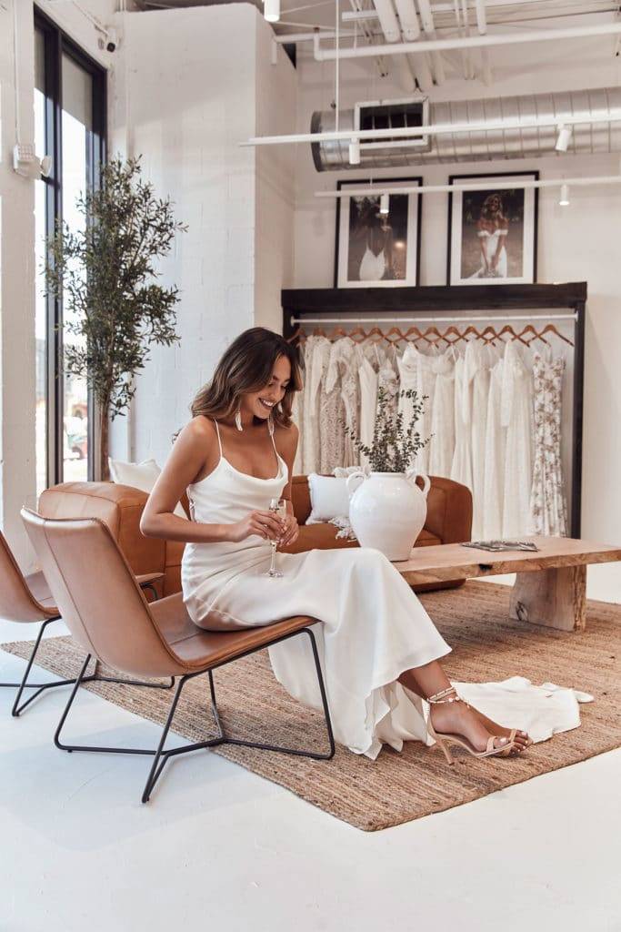 Bride in the Miami Grace Loves Lace showroom wearing the Dosa heels in sand and Honey Silk dress