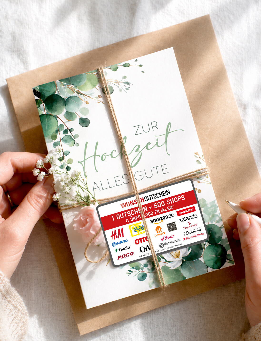 A hands holding a wedding card with floral design and gift card.