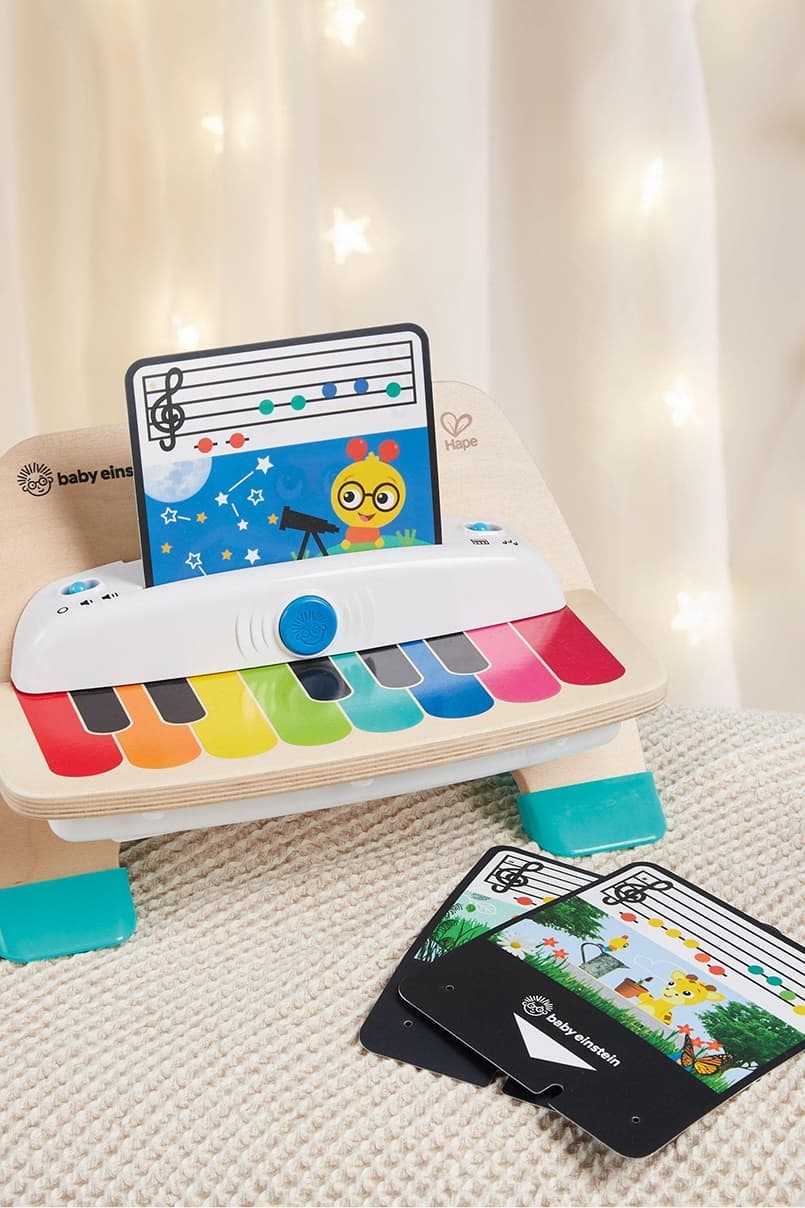 Colorful toy piano with music cards displayed in a soft-lit setting.