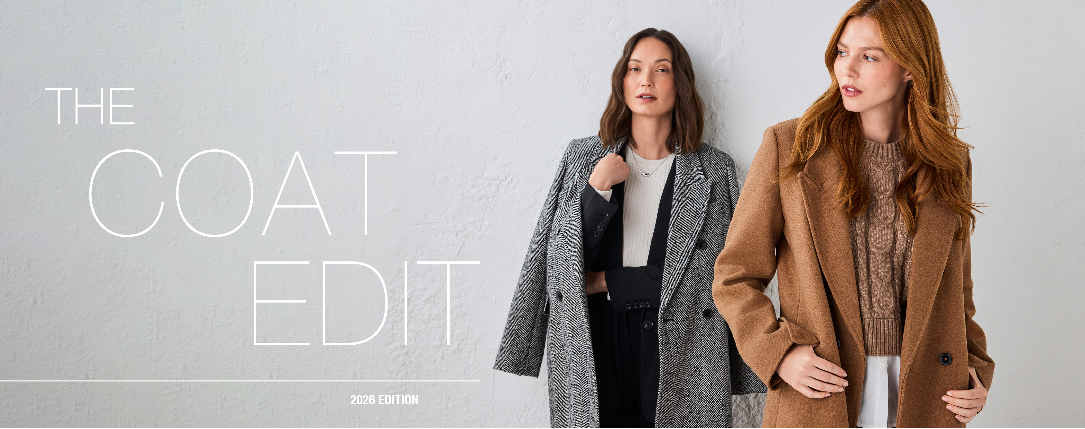 Two women wearing stylish coats against a light background.
