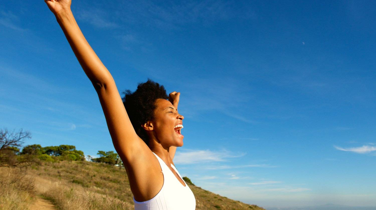 Featured | Side view portrait of overjoyed fit woman standing outdoors | Your Health Is A Journey, Not A Destination