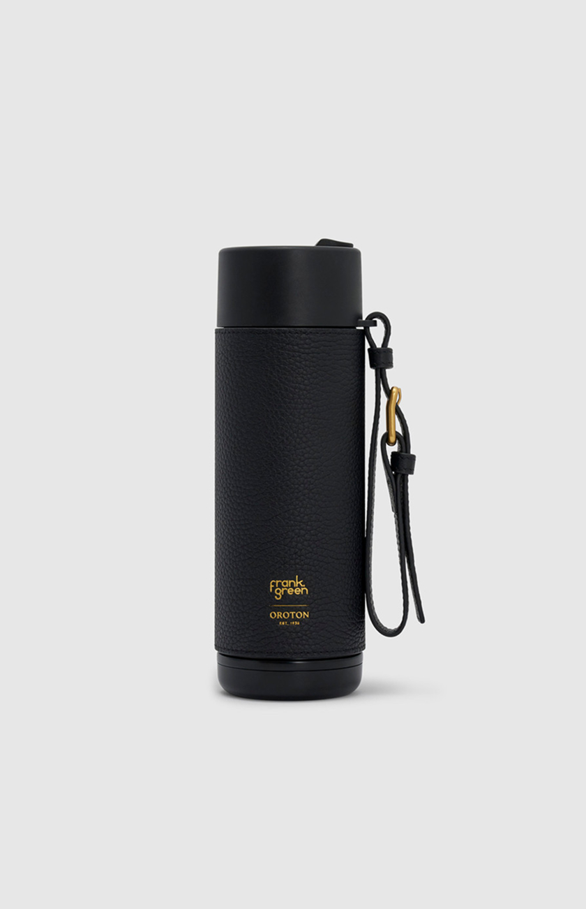 Black insulated travel mug with a handle and gold logo.