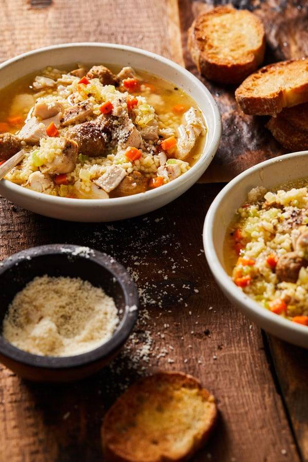 Brothy soup with mini meatballs,, pastina, and cheese.