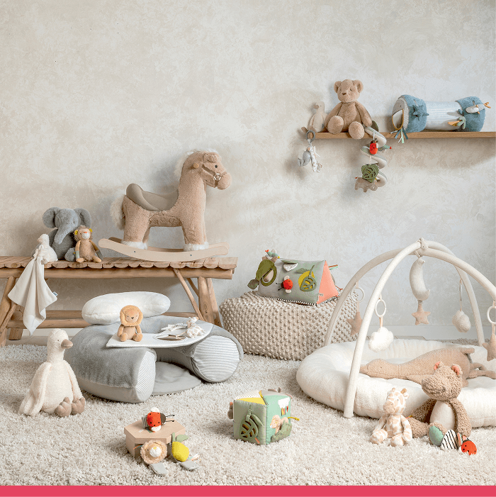 Cozy nursery with plush toys, a rocking horse, and a play area.