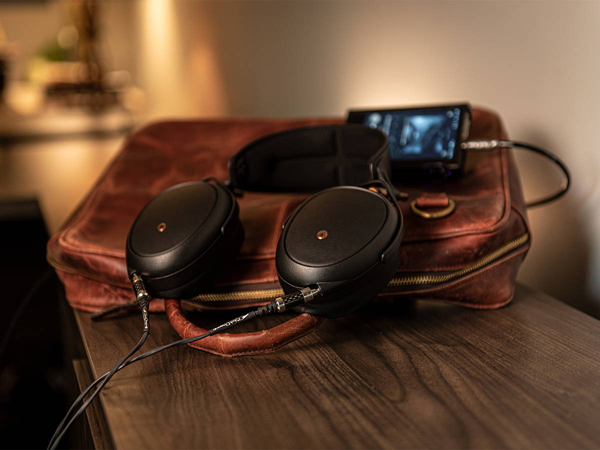 Meze Liric with Black Dragon Premium Cable on a leather bag