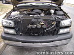 Four black Shocker XL train horns installed in front of radiator with hood open photo 4