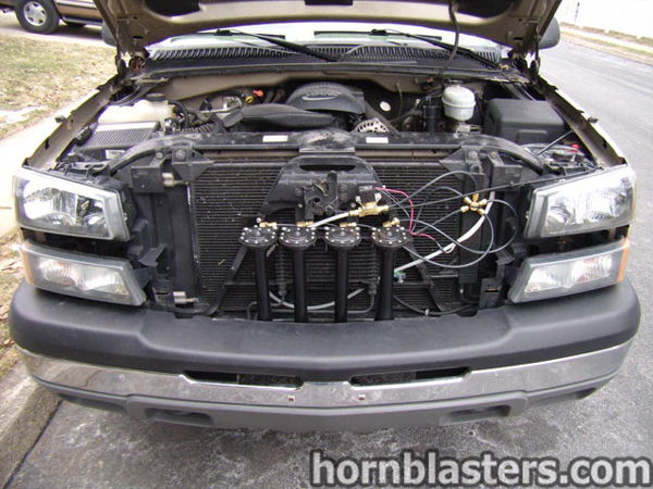 Four black Shocker XL train horns installed in front of radiator with hood open photo 4