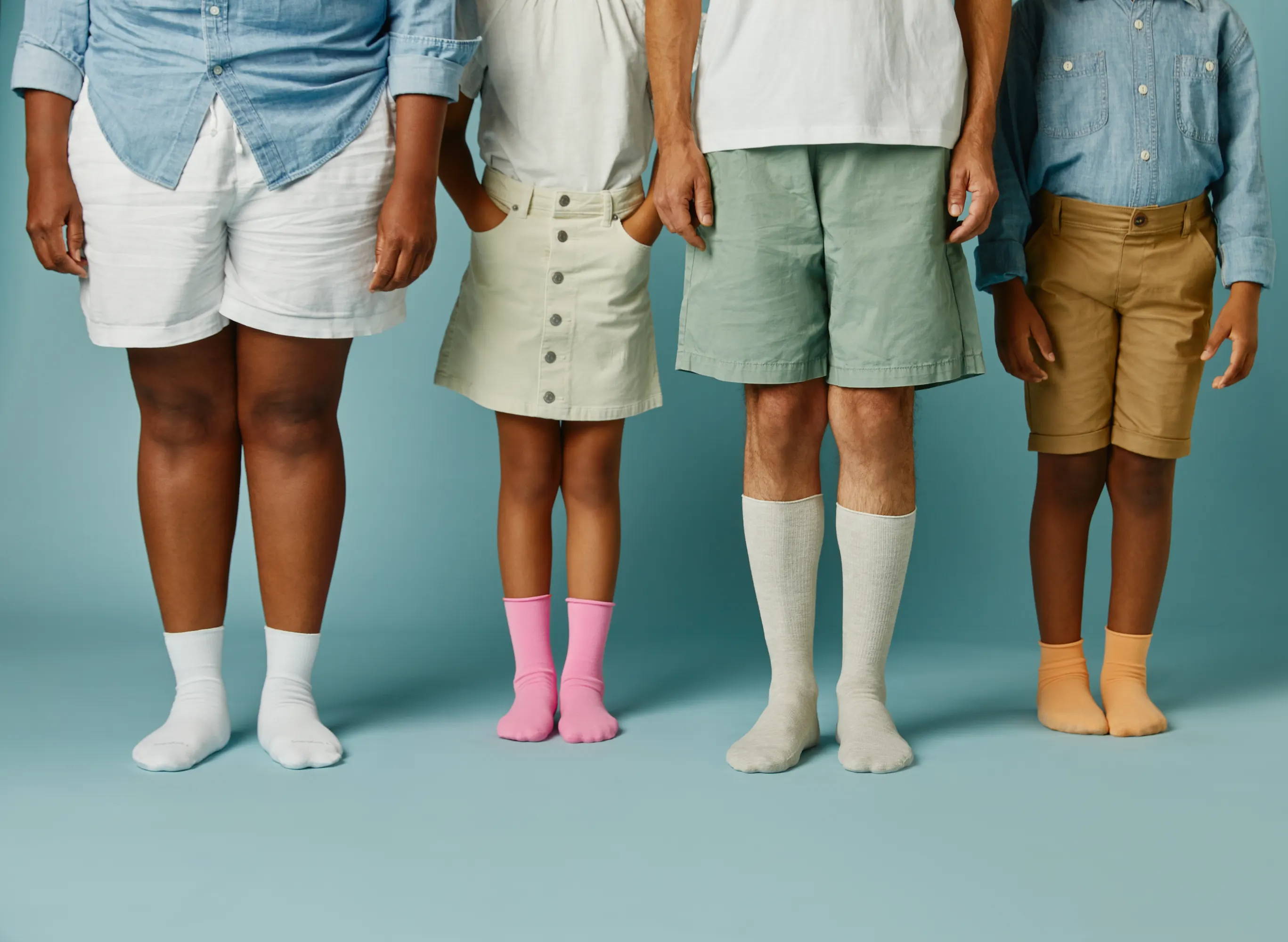 Family standing wearing SmartKnit socks and SmartKnitKIDS socks