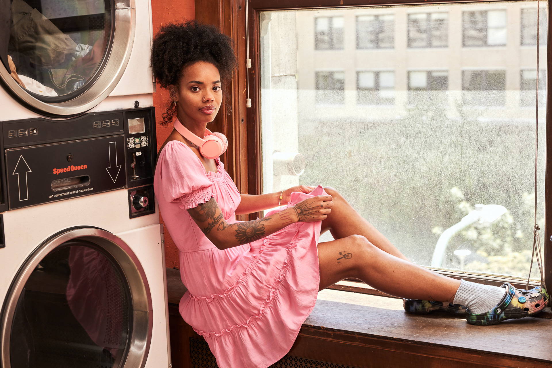 Trixxi Back to school embracing dorm life doing laundry and reading in a barbie pink tier dress.