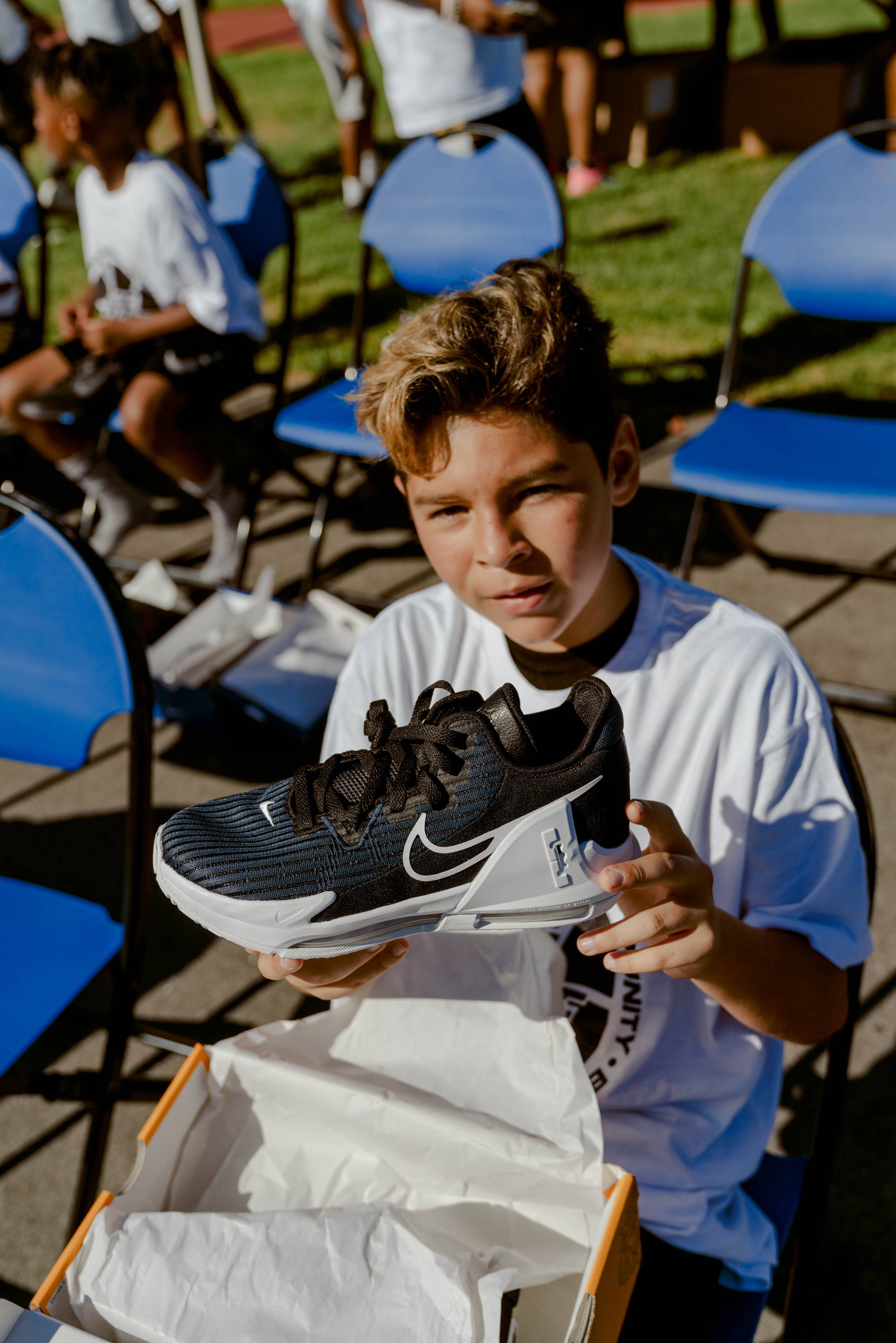 darby park hoop clinic boy opening new shoes