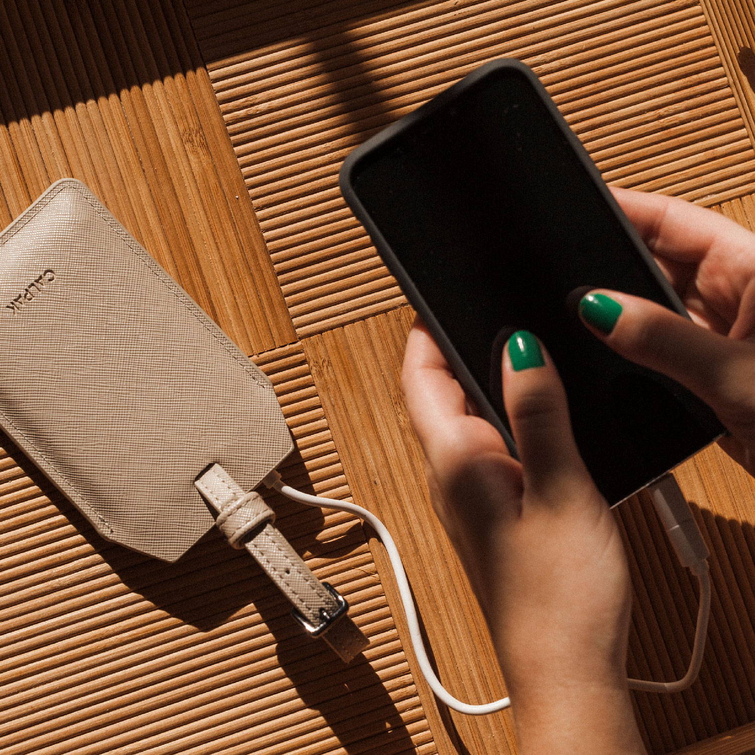 CALPAK Portable Charger with smartphone attached