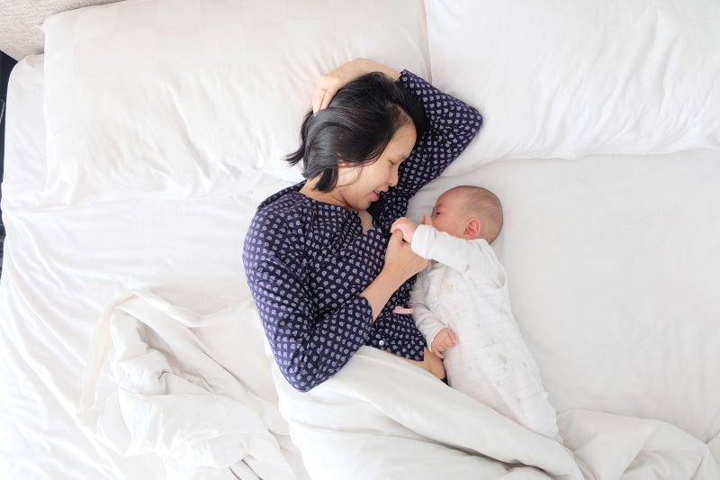 Woman With Baby In Bed