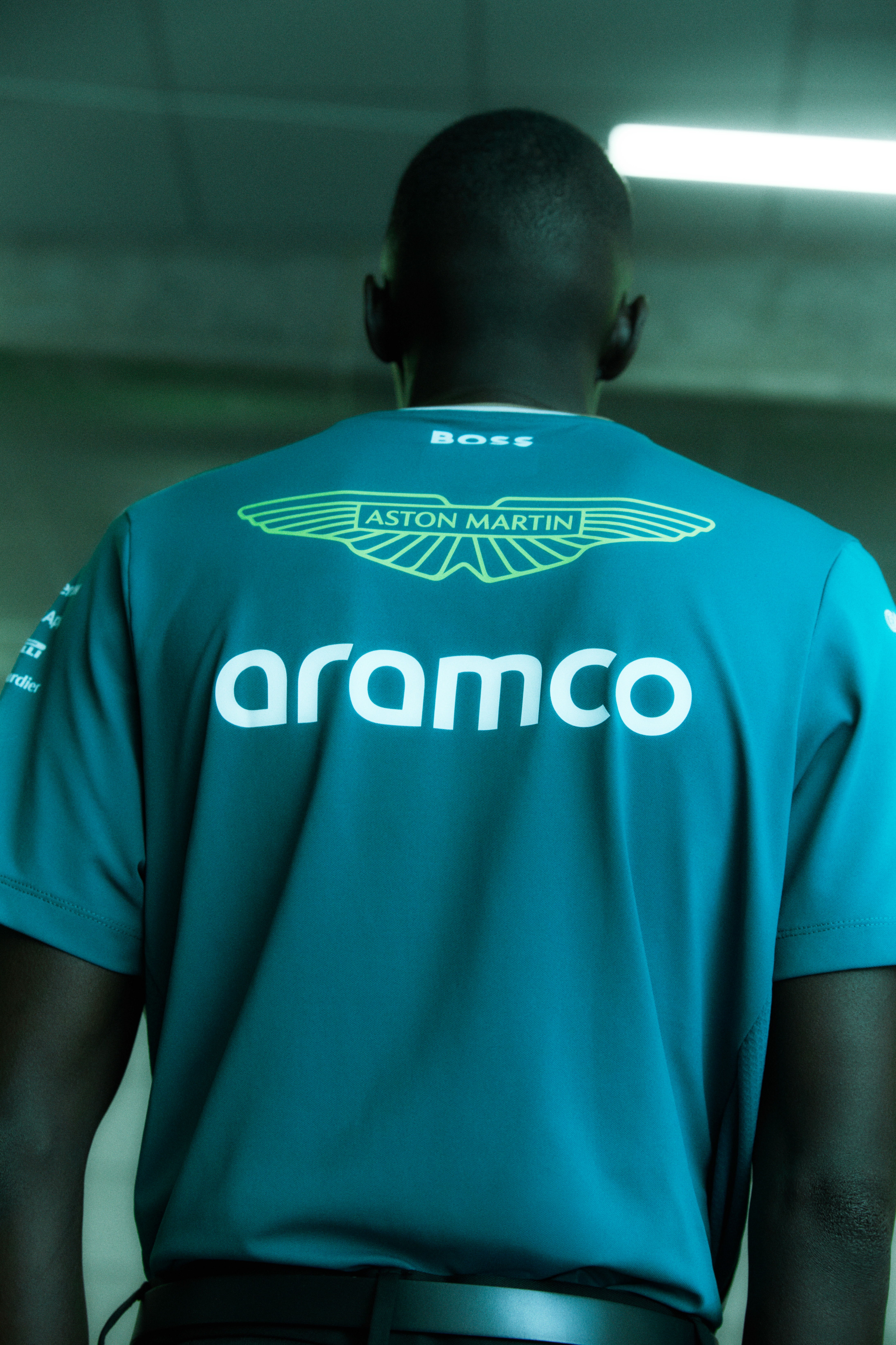 Person wearing an Aston Martin team shirt with 