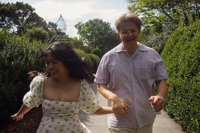 engaged couple running at north carolina arboretum