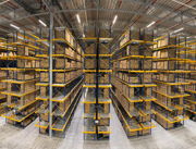Warehouse shelves filled with stacked boxes and organized storage.