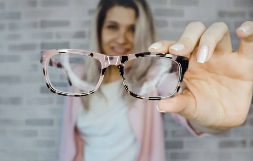 Femme tenant de nouvelles lunettes subissant une distorsion de la vision