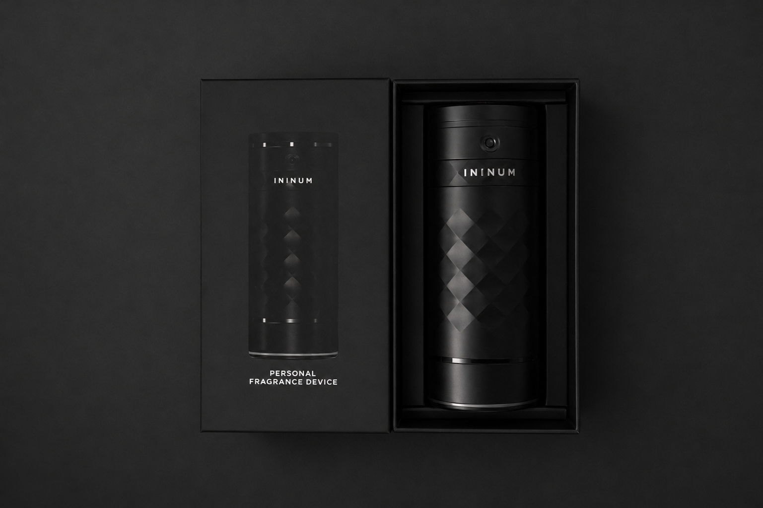 Black cylindrical product in a sleek black box on a dark background.