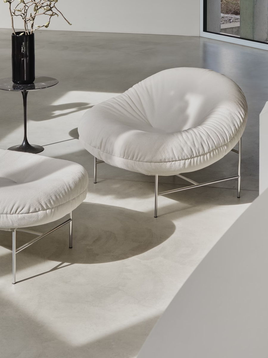 Perron Bun Lounge Chairs by Knoll with soft cushions and metal legs in a minimalist setting.