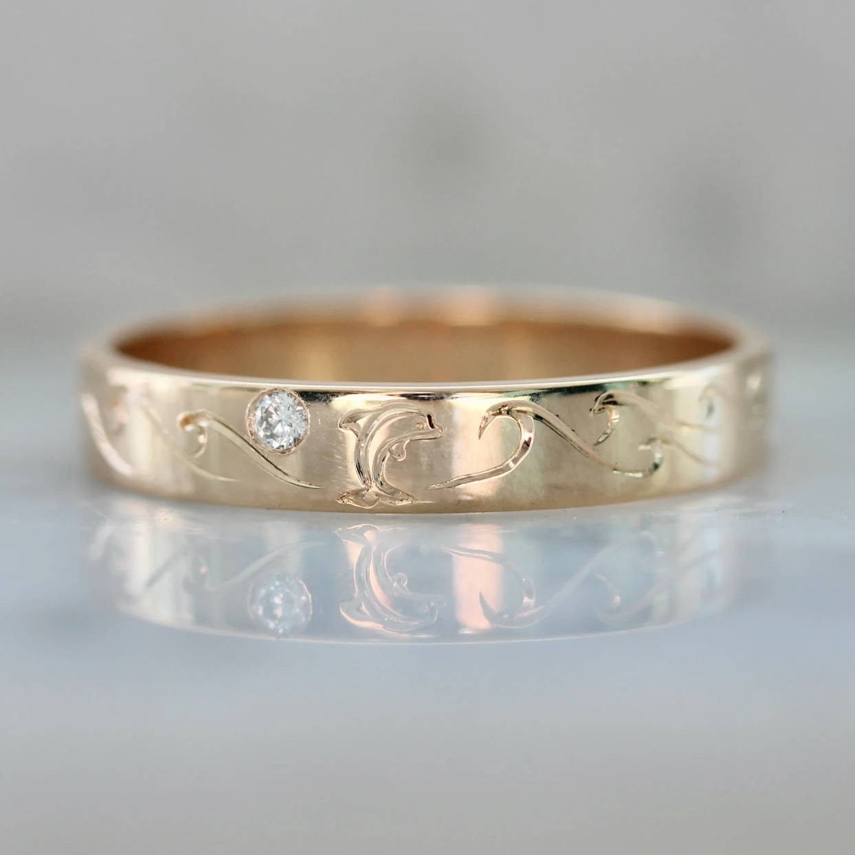 dolphin and ocean engraved gold band