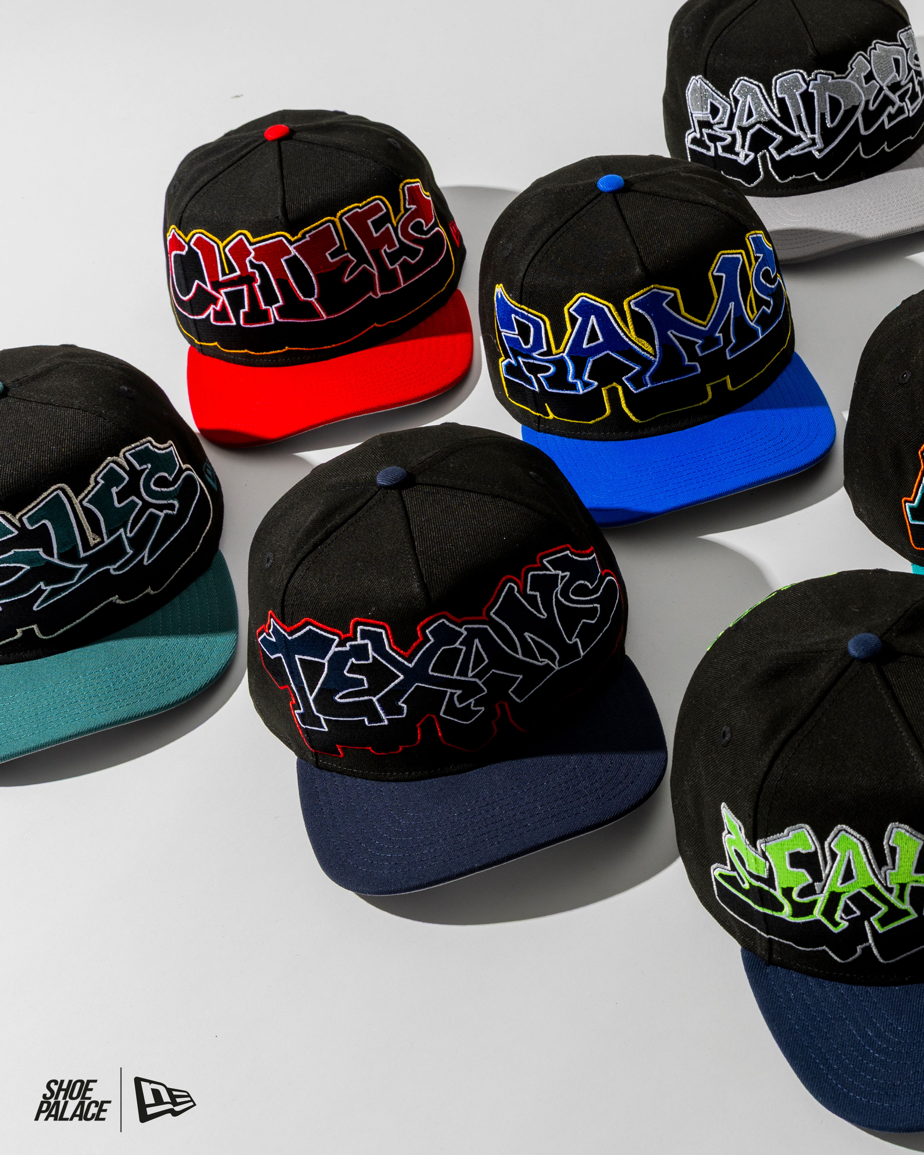 A collection of black caps with colorful team logos.