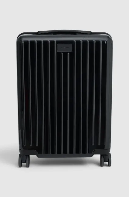 Black suitcase with vertical stripes and wheels, facing forward.