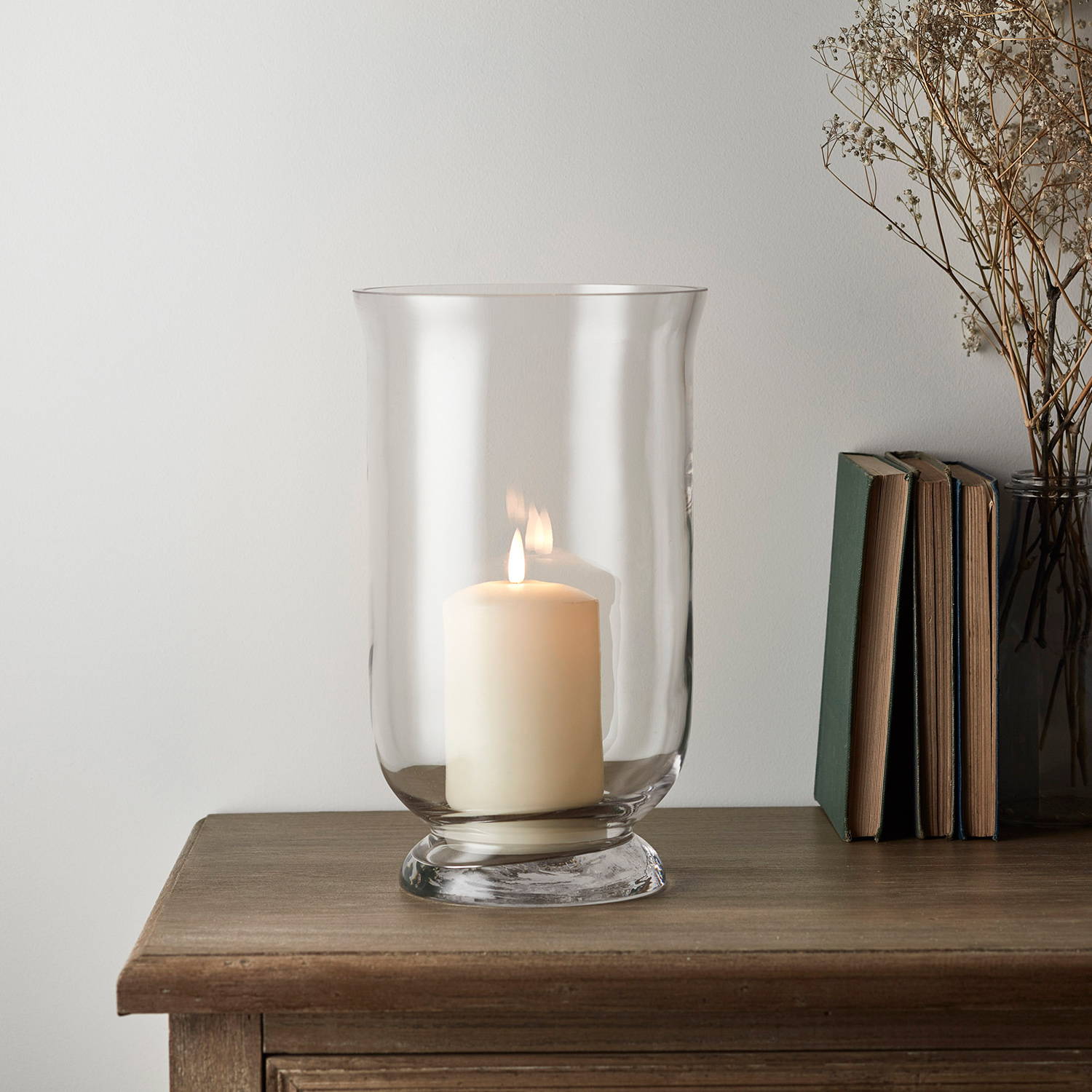 Illuminated TruGlow candle in hurricane jar
