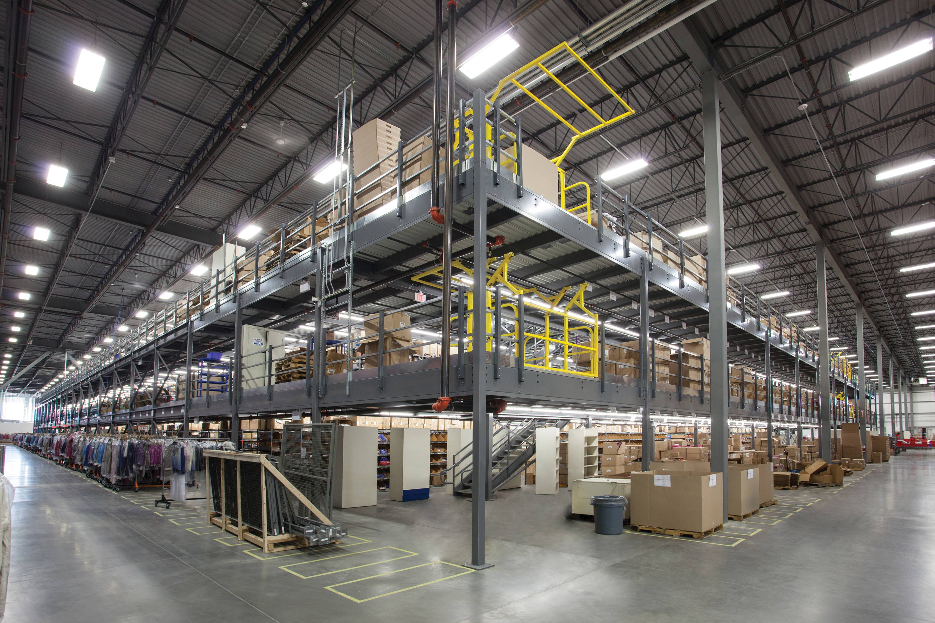 Large, two-story mezzanine with a mezzanine gate on each floor. Used in a warehouse for extra storage. LED Lighting installed on each level of the mezzanine.