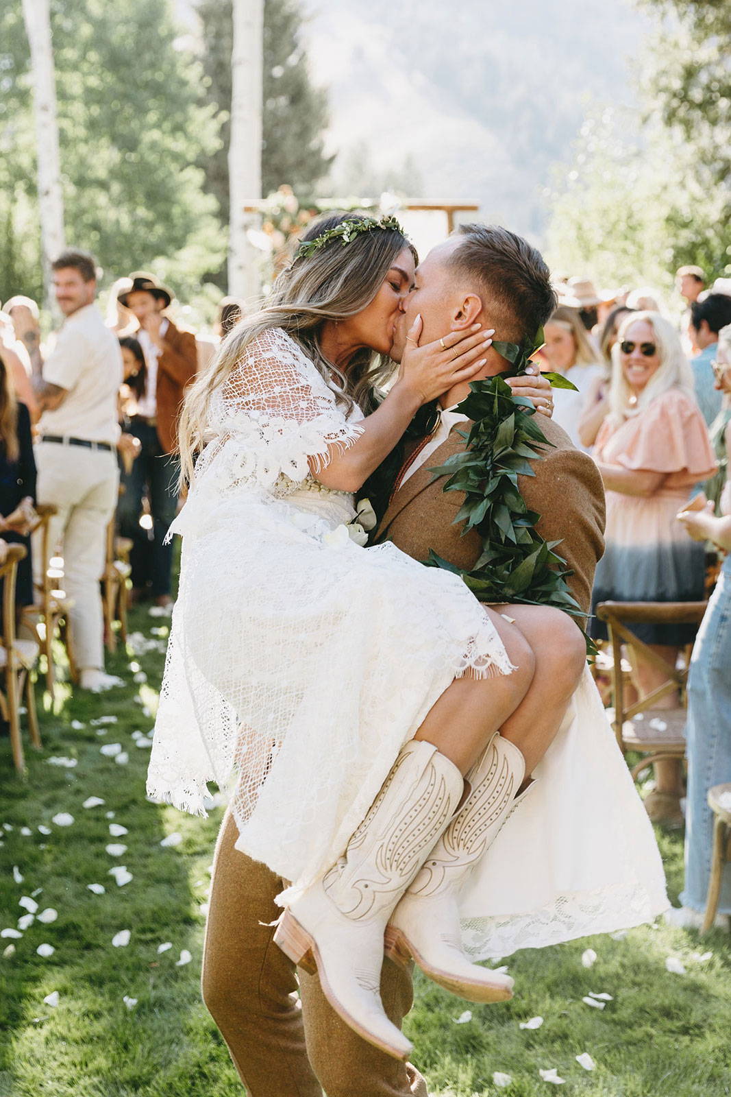 Bride and groom kissing down the aisle