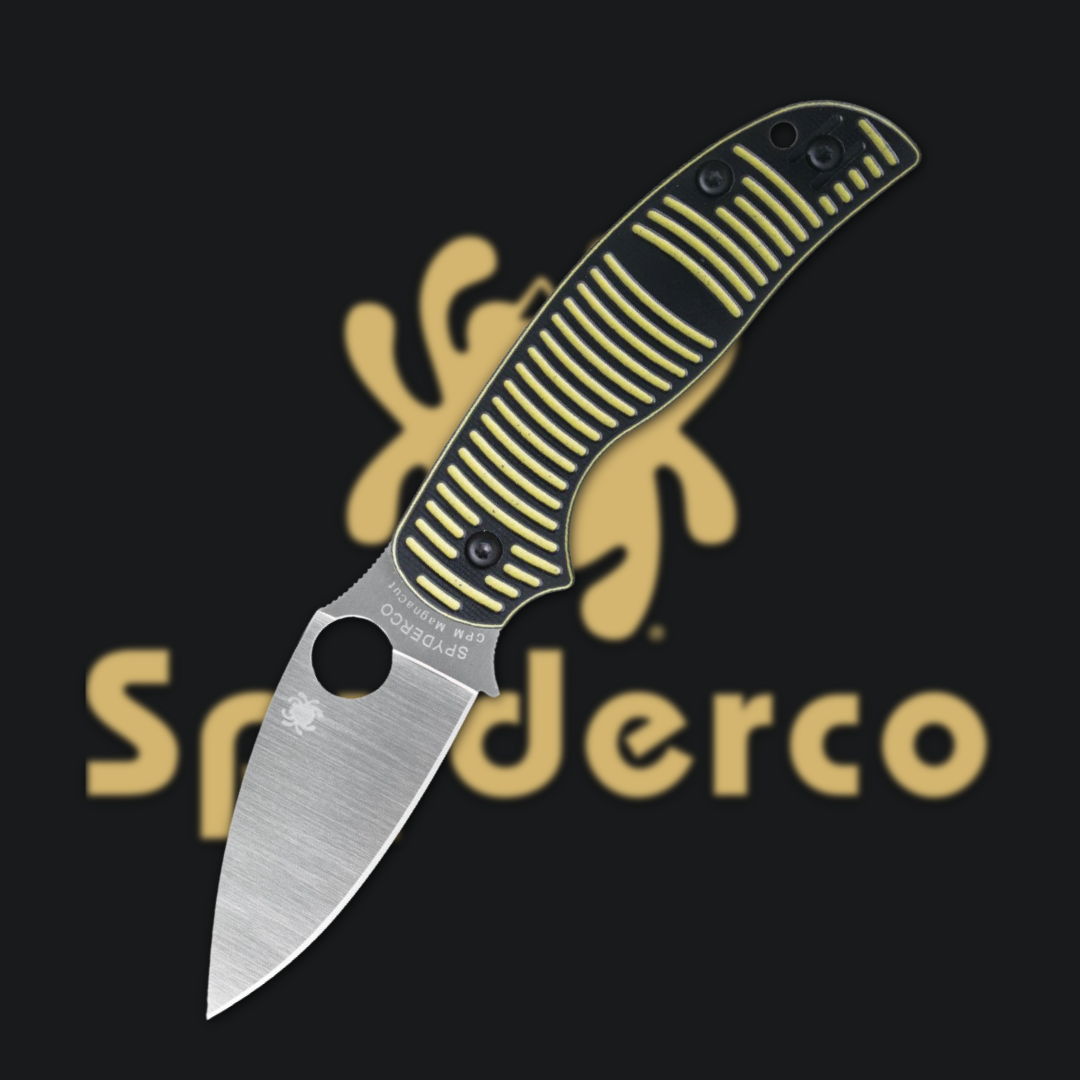 Knife with a yellow and black handle, against a black background.