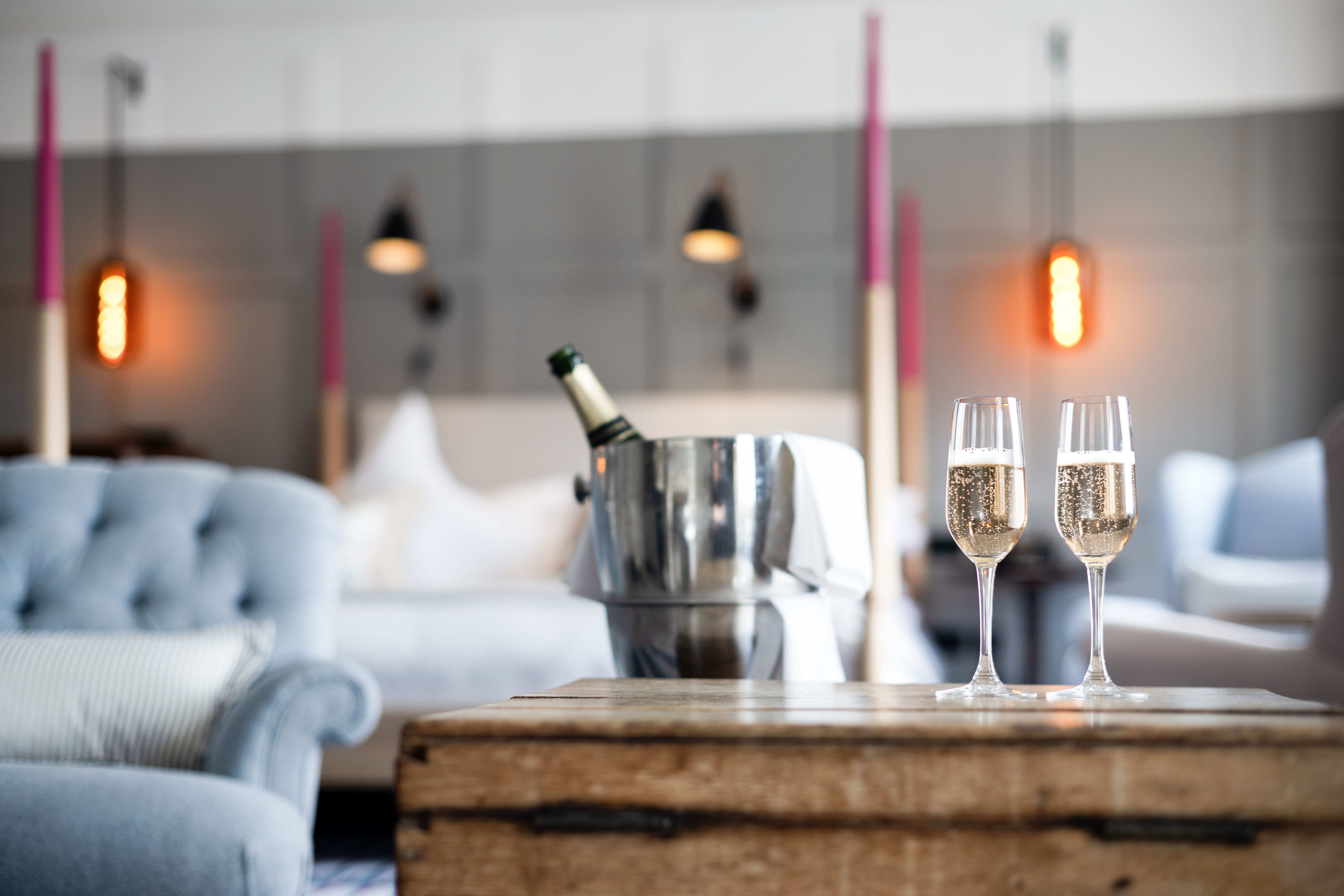 Chic living room with champagne, glasses, and cozy seating.
