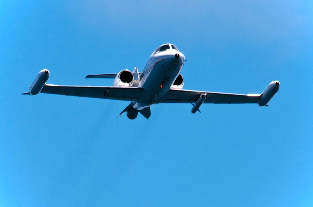 An LJ-35 Learjet flies over the amphibious assault ship USS Kearsarge (LHD 3) during a detect to engage exercise, testing the ship's ability to track and engage enemy aircraft. Kearsarge is underway conducting Afloat Training Group 2.3/2.4 basic phase training. (U.S. Navy photo by Mass Communication Specialist 1st Class Tommy Lamkin)