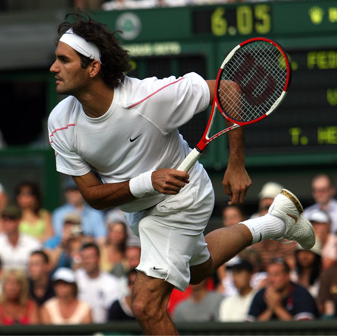 Tennis player in action, preparing to hit a ball during a match.