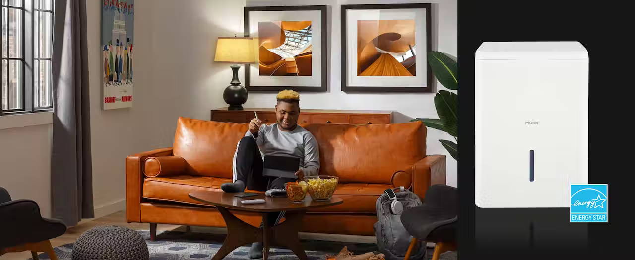 Millennial relaxing on couch with an iPad and snacks.