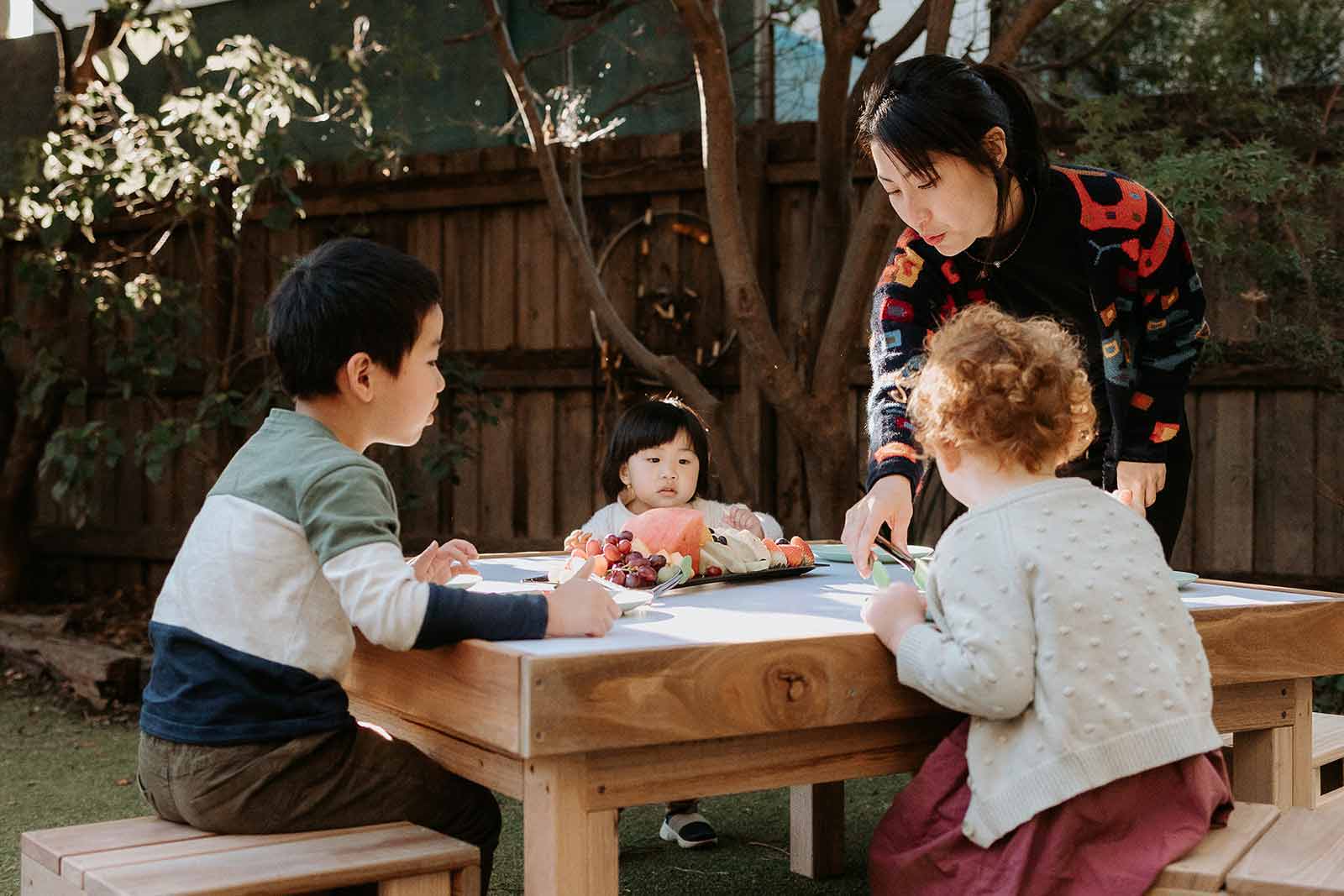 Kids at Childcare having morning tea at their timber outdoor table