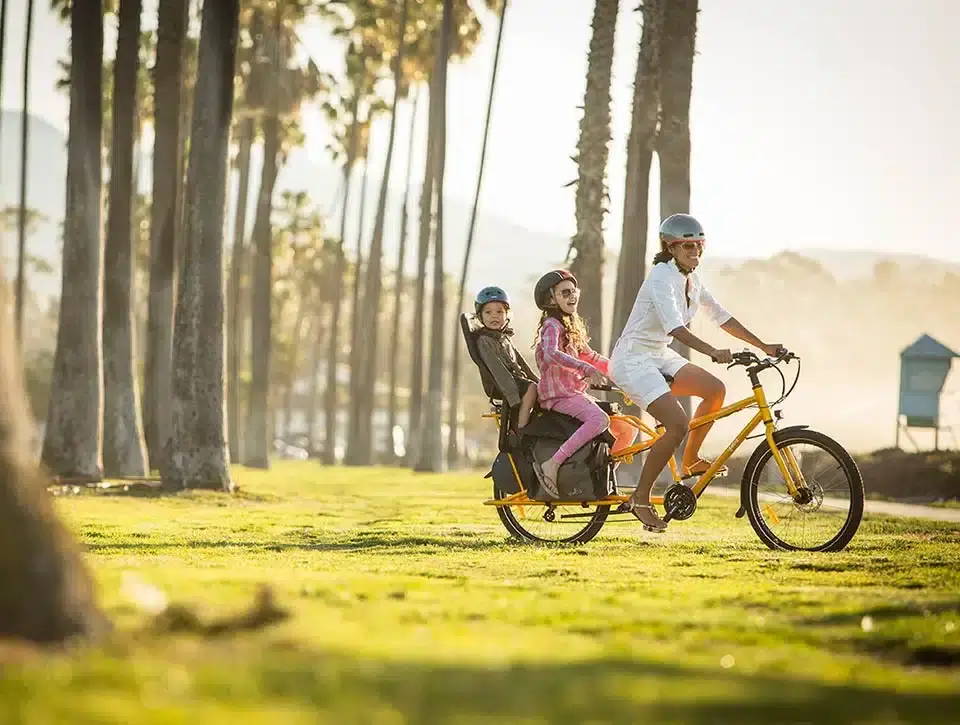 Family riding a Yuba bike