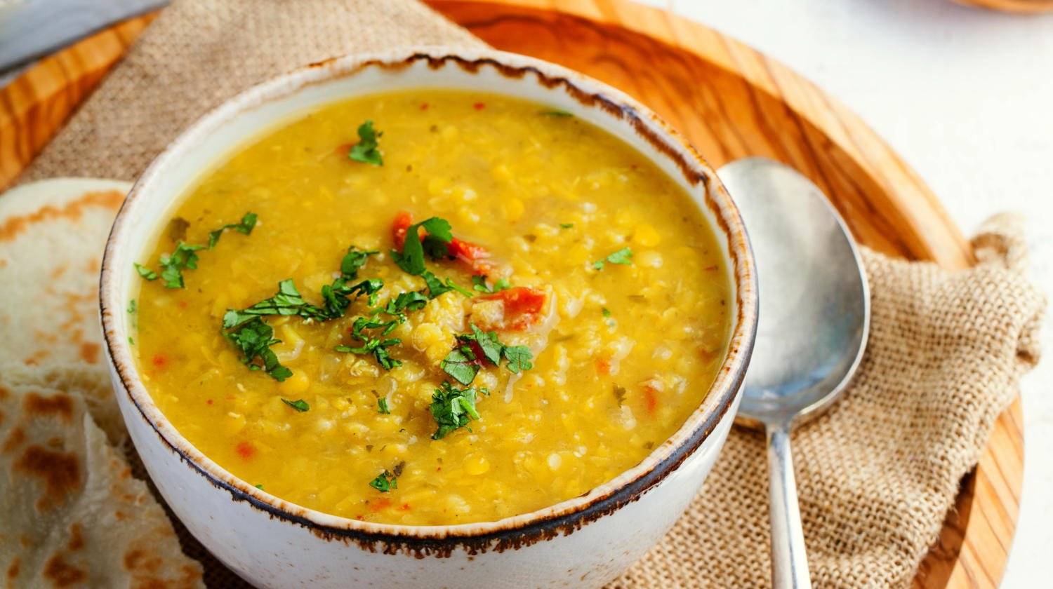 Lentil soup with pita bread in a ceramic white bowl  | Delicious Vegan Soup Recipes Perfect For the Fall Weather | fall vegetarian soup | Featured