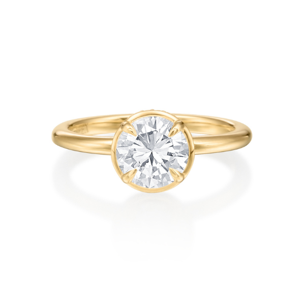 Gold ring with a large round diamond setting.