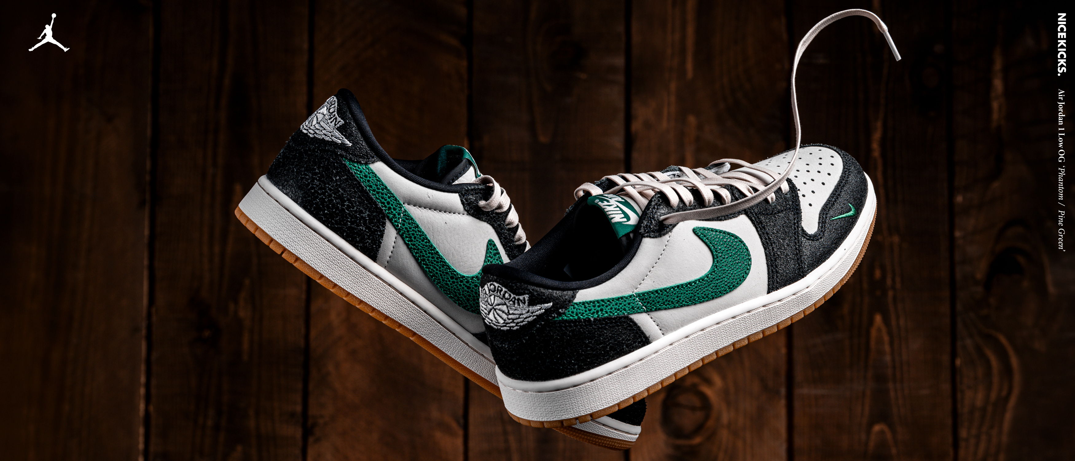 A pair of stylish sneakers with green and black accents on a wooden background.