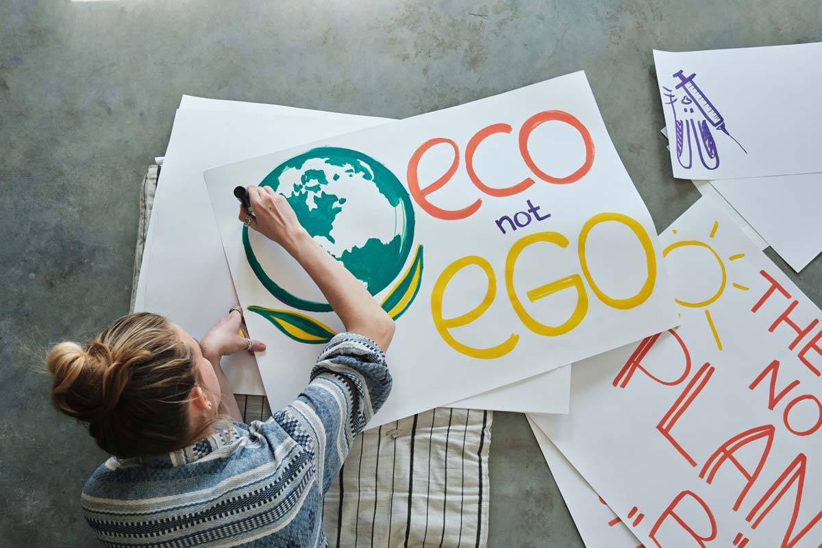 Eco not Ego protest sign being drawn