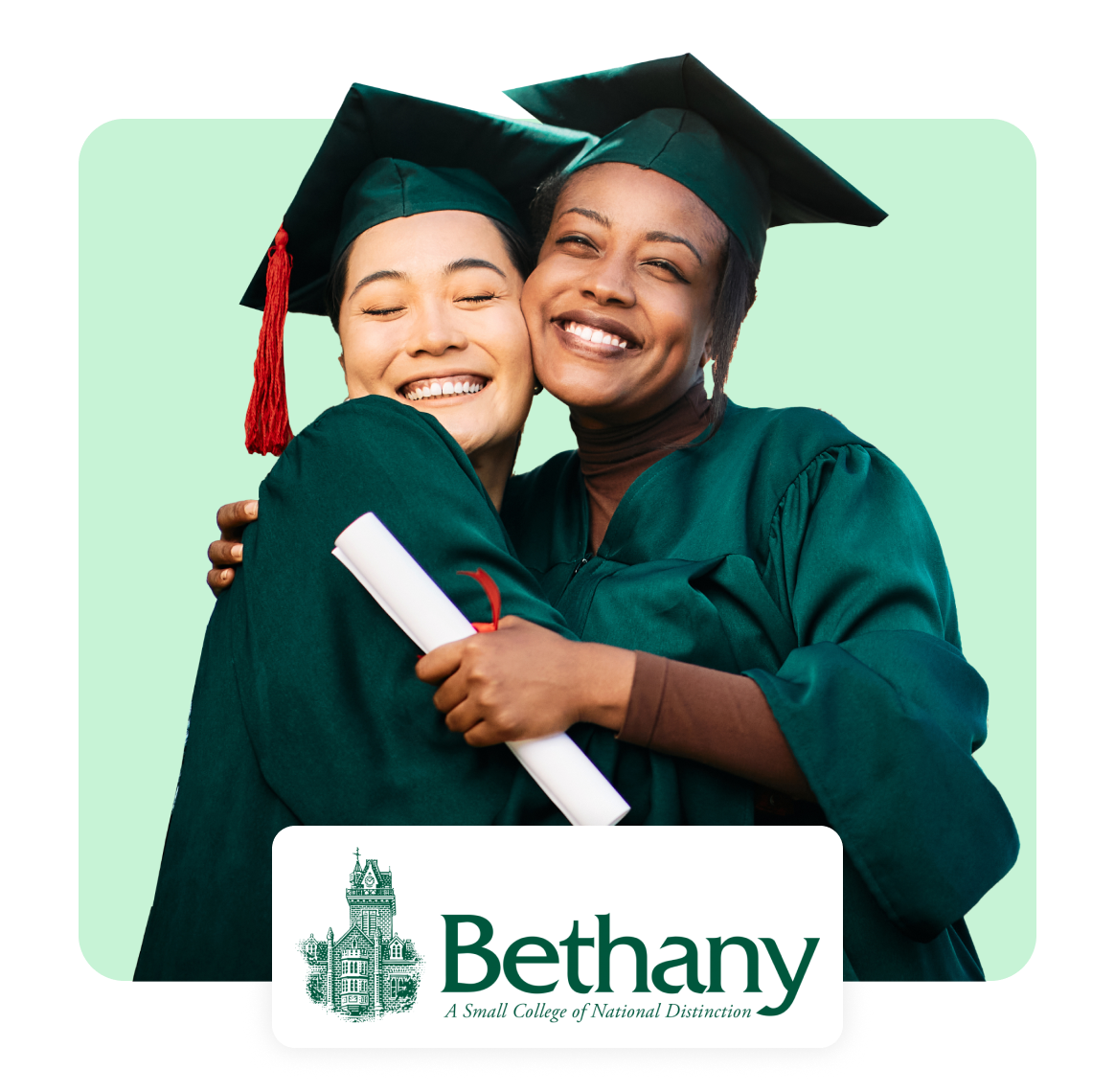 Two smiling graduates in caps and gowns hugging, holding a diploma.