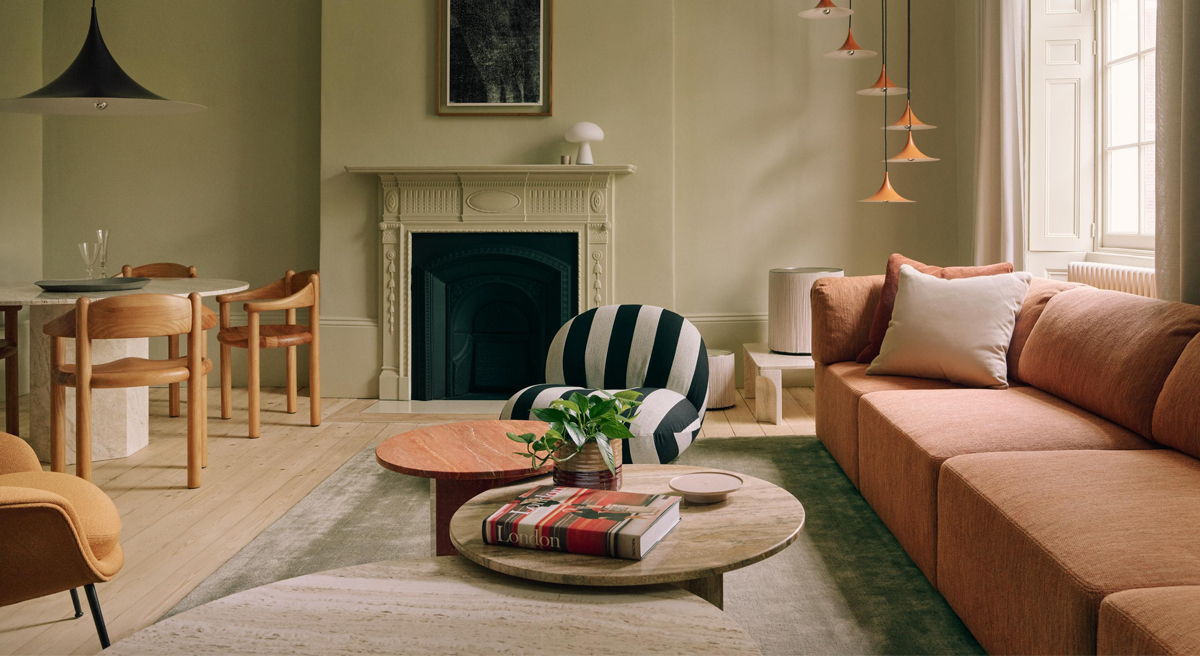 Cozy living room with a sofa, coffee table, and dining area.