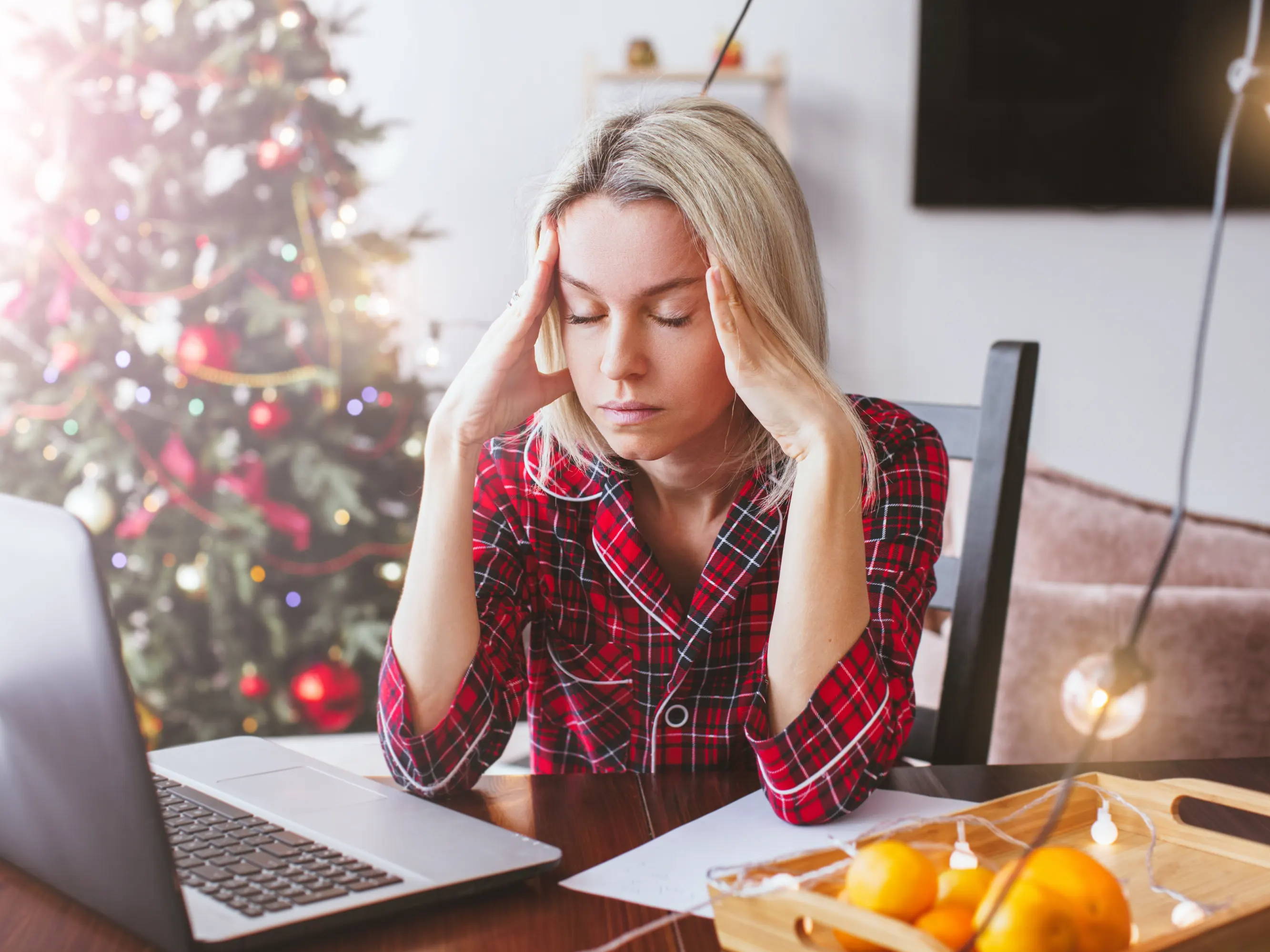 Woman stressed out at desk around holidays