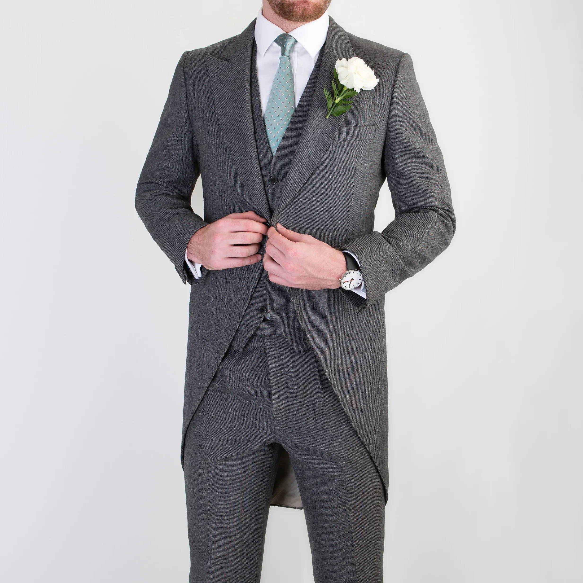 Groom wearing bespoke three piece wedding suit with morning coat by Mullen and Mullen bespoke tailoring