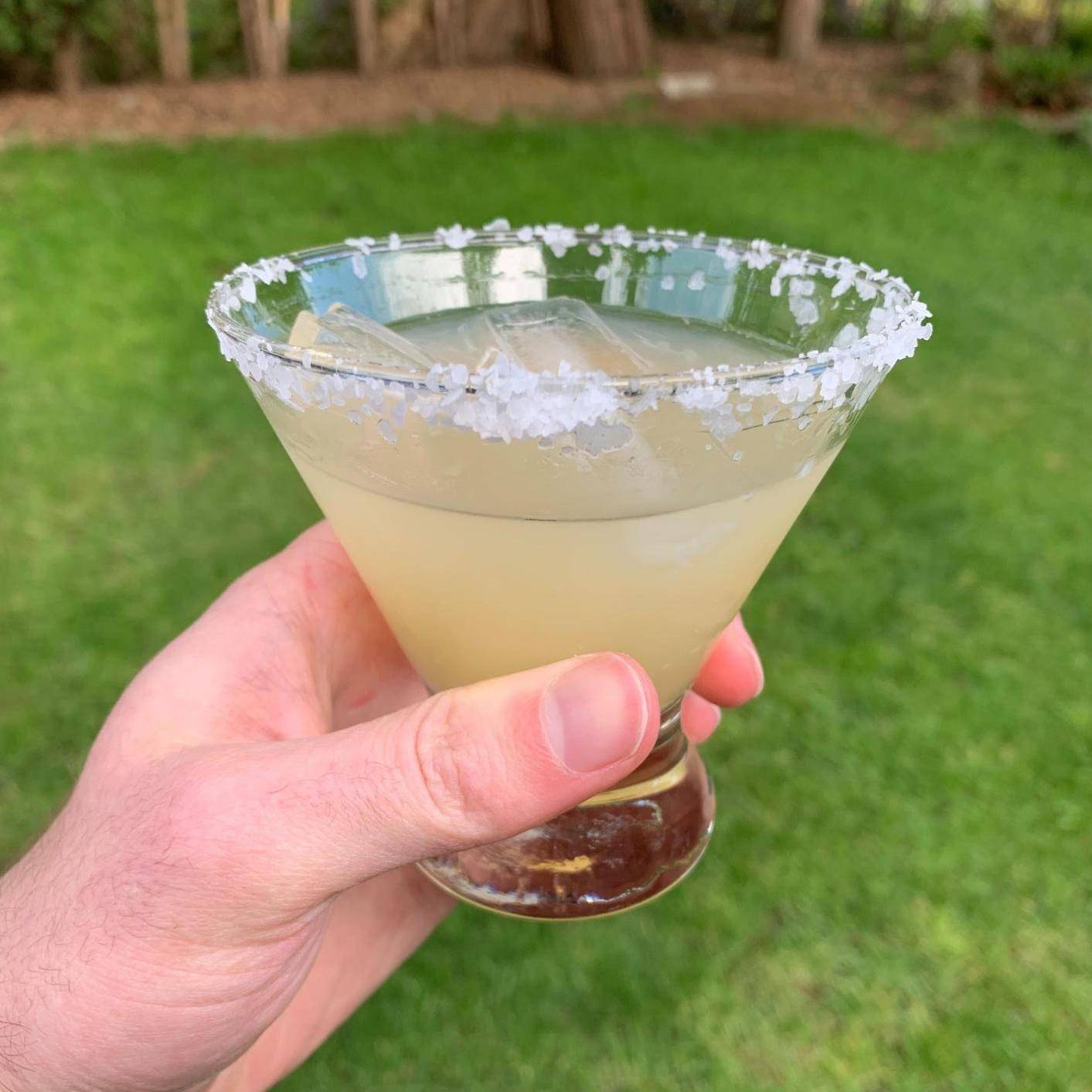 Tommy's Margarita with salt on the rim in the backyard