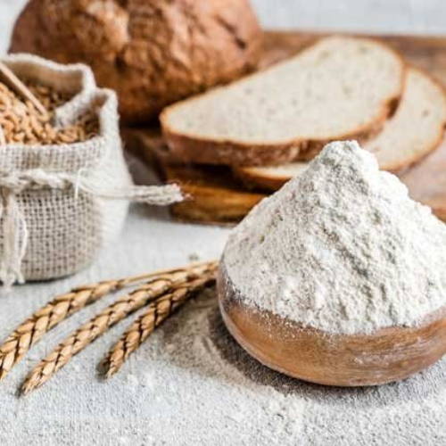 Bowl of flour with wheat and bread