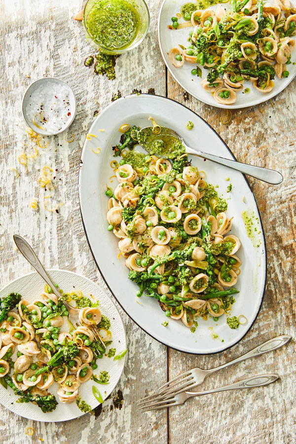 Orecchiette pasta with sweet peas, broccoli rabe and green onions in a pesto sauce.