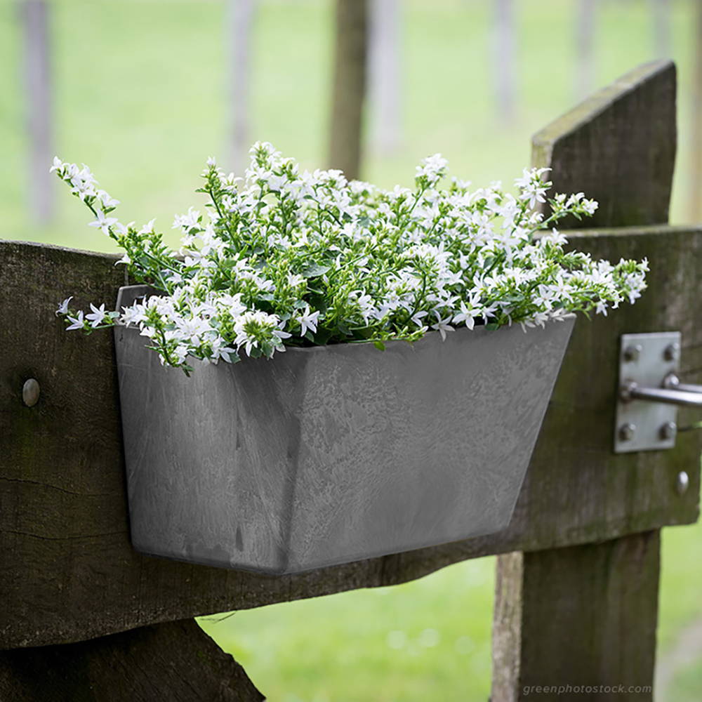 Gray Ella wall planter affixed to outdoor fence